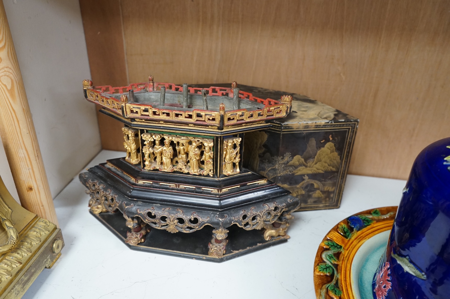 A Chinese lacquered and carved wood temple ornament, 26.5cm high, 32cm widest on base.